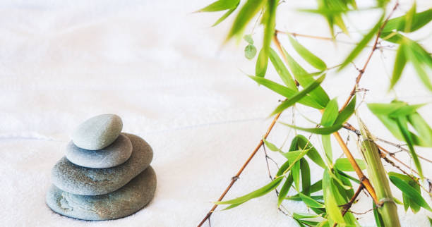 istock Stack of balancing stones with bamboo at a health and beauty spa 1290280666