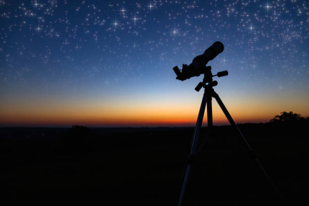 istock Silhouette of a astronomy telescope with twilight sky. 1290280741