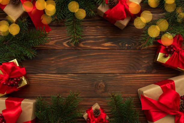 istock Christmas background with decorations, gift boxes and lights on wooden table. Top view. Copy space.  Merry christmas and happy new year celebration concept 1290284161