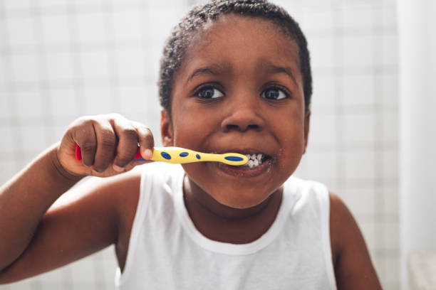 istock Happy Young Boy Washing his Teeth in a Bathroom 1290287592
