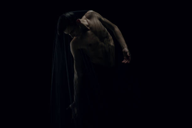 Coming. Graceful classic ballet male dancer isolated on white studio background. Man in minimalistic black cloth looks graceful, inspired. The grace, artist, movement, action and motion concept.