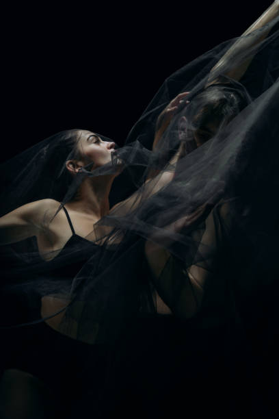 istock Graceful classic ballet dancers isolated on black studio background. The grace, artist, movement, action and motion concept. 1290288065