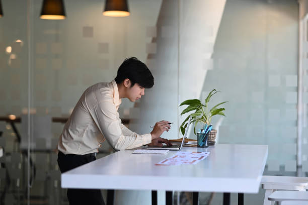istock A male designer working on browsing information for project on computer laptop at office. 1290288279