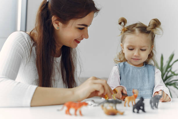 istock Tutor with litthe girl studying at home 1290293235