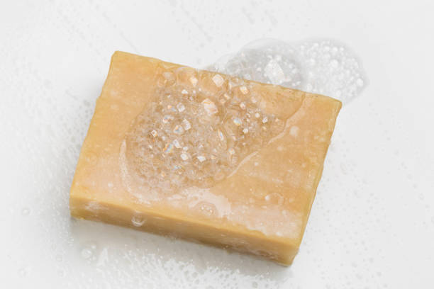 istock Soap bar and foam on white background 1290298681