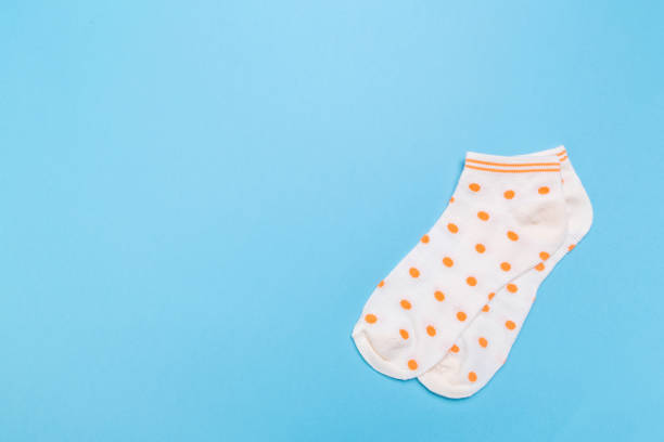 istock yellow new socks stacked on a blue background. top view. 1290299031