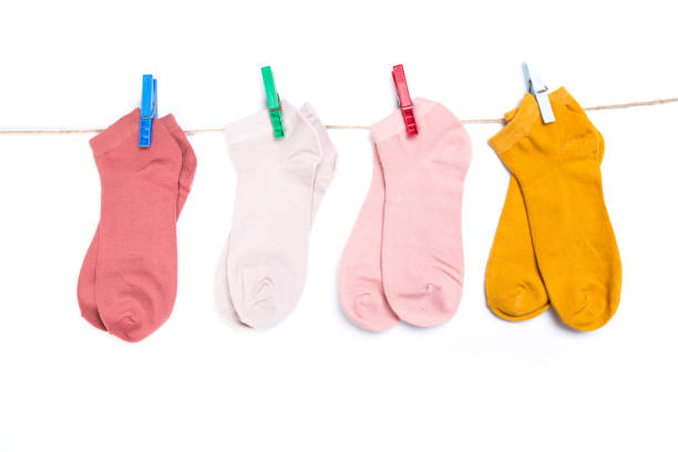 istock several colored new short socks hanging on a rope with clothespins isolated on white background 1290299457