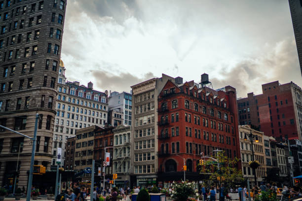 istock Aged apartment buildings on crowded street 1290299643