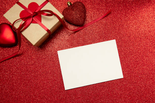 istock red valentine's day background with gift and hearts and white sheet for copy text 1290300841