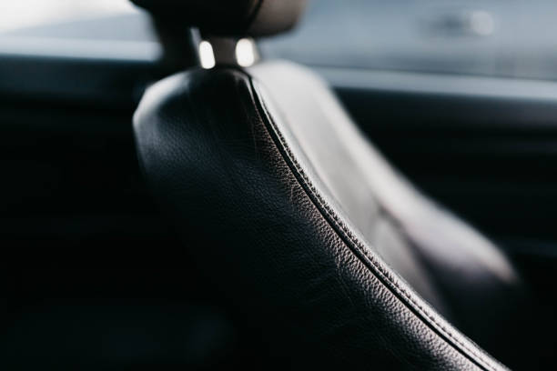istock black leather interior of a business class car, seams. 1290300899