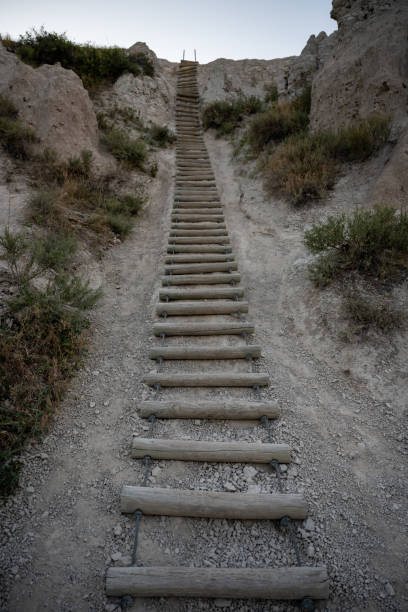 istock Long Wooden Ladder Climbs up Hoodoo Wall 1290302454