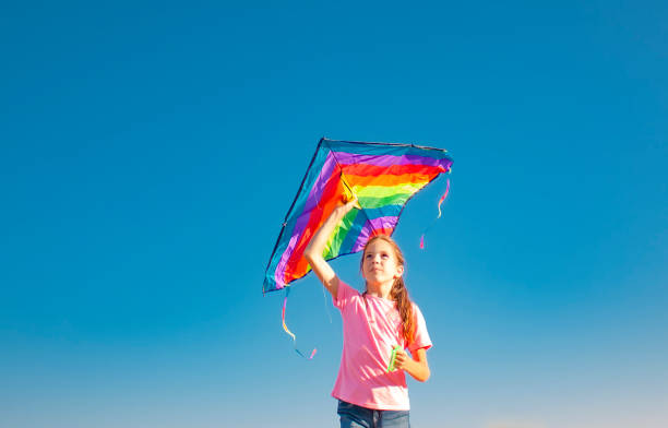 istock a girl about to fly a kite into the sky 1290303075