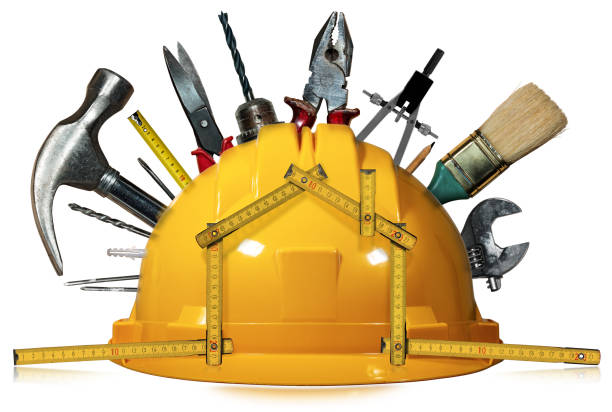 casco di sicurezza con strumenti di lavoro e righello pieghevole a forma di casa - adjustable wrench wrench orange hand tool foto e immagini stock