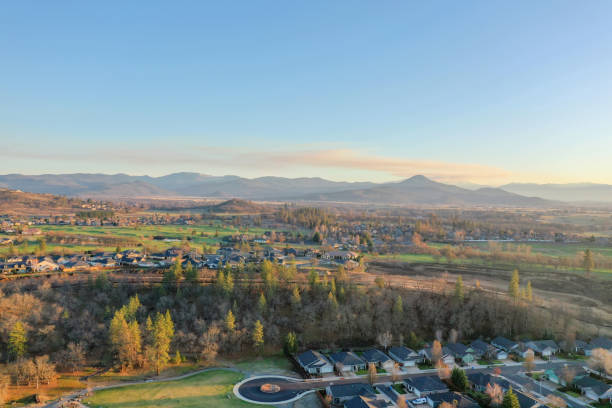 istock Peaceful town surrounded by trees with mountains as background 1290305453