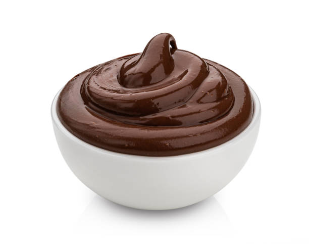 istock Bowl of chocolate cream isolated on white background 1290306429