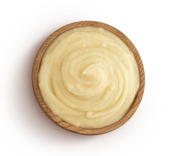 istock Mashed potato puree in wooden bowl isolated on white background, top view 1290306517