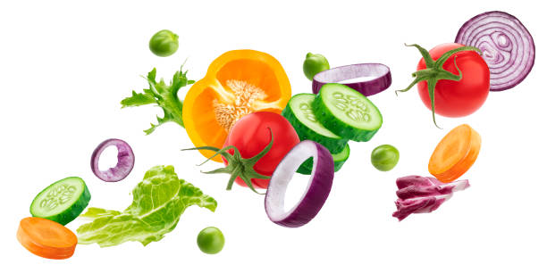 Falling vegetables, fresh salad ingredients isolated on white background