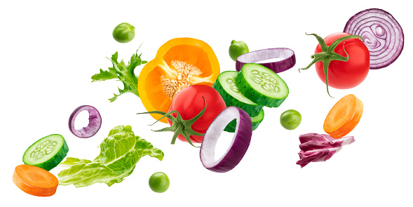 Falling mix of different vegetables, fresh salad ingredients isolated on white background