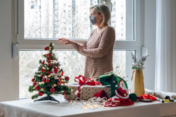 istock Senior woman wrapping presents 1290306994