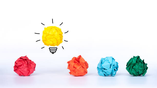 istock Creative idea. Concept idea and innovation with paper light bulb with colorful crumpled paper. 1290307545