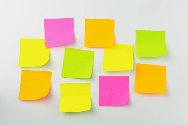 istock Collection of different colored sheets of note papers the stick on the wall, ready for your message. 1290307740