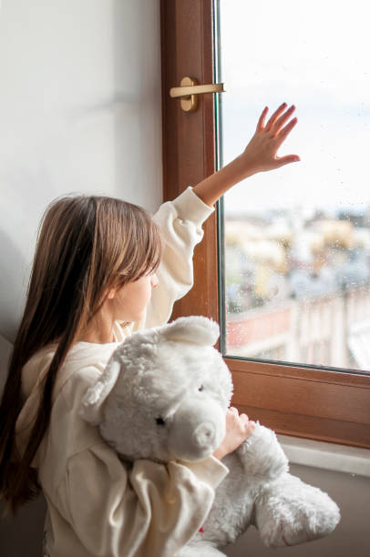 istock Cute girl boring at home with her teddy bear 1290310639