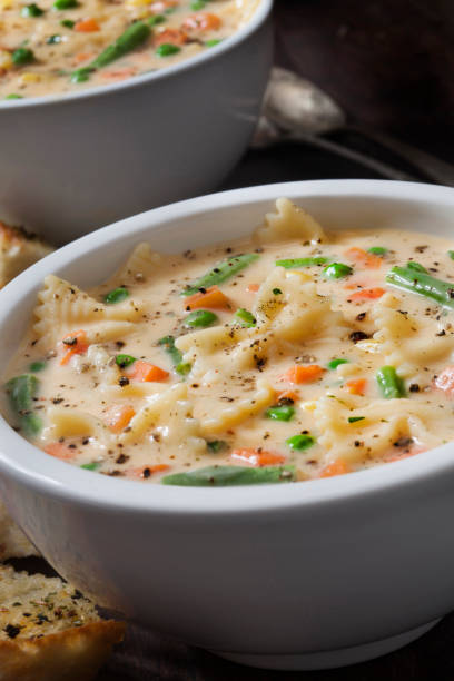 istock Creamy Macaroni and Cheese Soup with Bow Tie Pasta Garlic Bread 1290311143