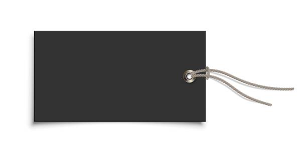 istock Empty paper black clothing label with metallic rivet and grey ribbon on white background. Blank tag of clothes for design logo print, company message, customer information. Vector realistic object. 1290311347