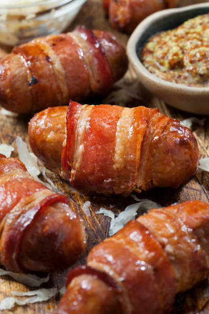 istock Mini Bacon Wrapped Bratwurst Sausages with  Sauerkraut and Grainy Mustard 1290312507