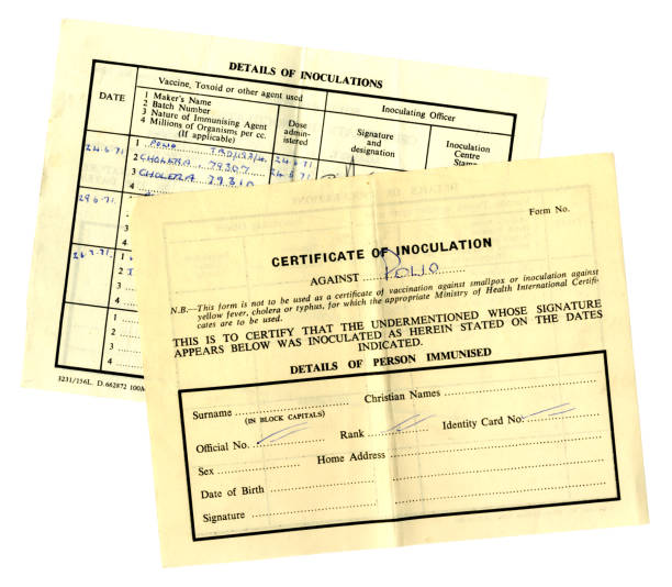 Two 1970s inoculation certificates Two old inoculation certificates from the 1970s. polio virus photos stock pictures, royalty-free photos & images