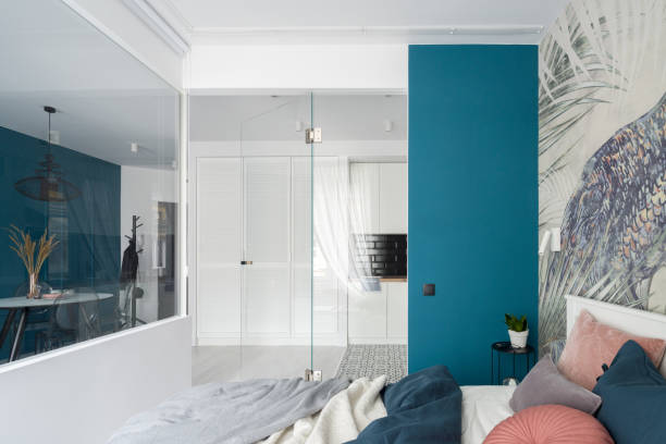 istock Stylish bedroom with glass doors and walls 1290313548