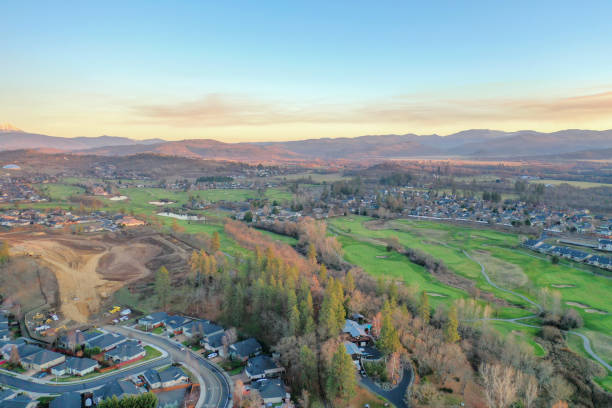istock Peaceful town surrounded by trees with mountains as background 1290314249