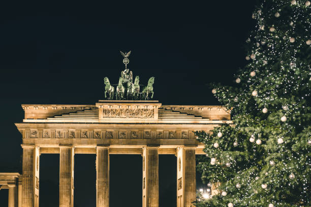 istock Brandenburger Tor behind festive iluminated christmas tree at night 1290314638