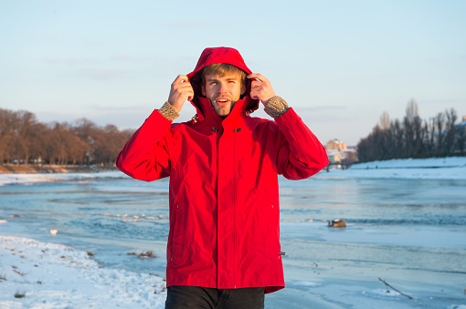 Exploration of polar regions. Winter destinations. Winter fishing. Safety measures. Polar explorer. Winter menswear. Winter outfit. Comfortable outfit. Man warm jacket snowy nature background.