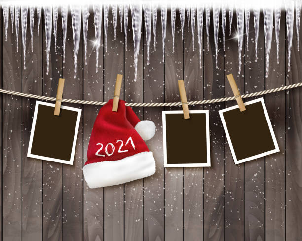 ilustrações de stock, clip art, desenhos animados e ícones de merry christmas and new year holiday background with photos and a santa hat with 2021 on the rope. vector. - natal fotos