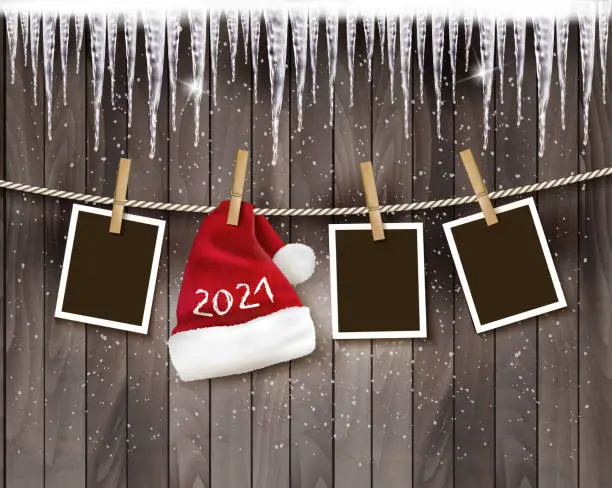 Vector illustration of Merry Christmas and New Year Holiday background with photos and a santa hat with 2021 on the rope. Vector.