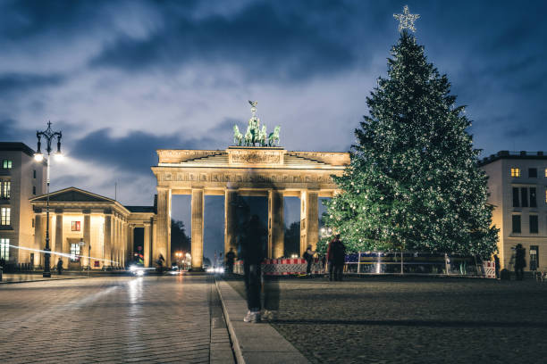 istock Brandenburger Tor behind festive iluminated christmas tree at blue hour 1290314817