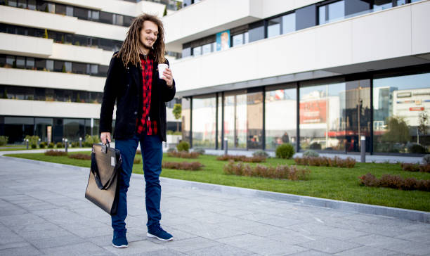 istock Student with dreadlocks drink a coffee and goes to university 1290315956