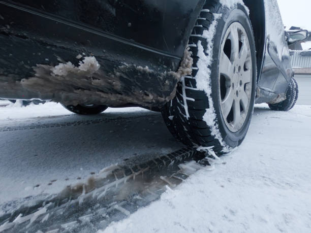 istock Car tires on winter road 1290317497
