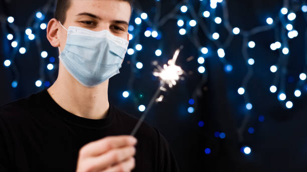 istock Man with face mask and sparkler 1290317565