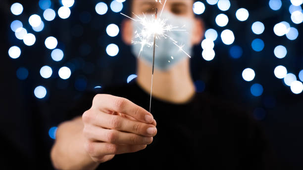 istock Man with face mask and sparkler 1290317573