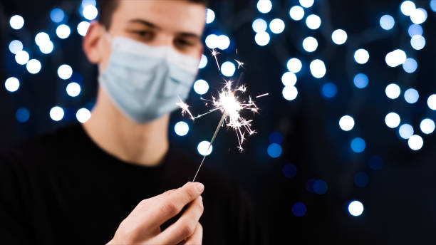 istock Man with face mask and sparkler 1290317579