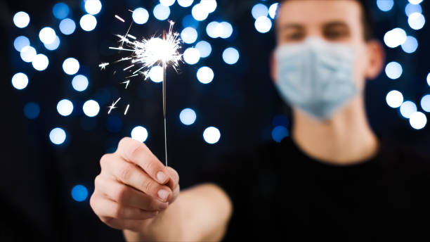 istock Man with face mask and sparkler 1290317582