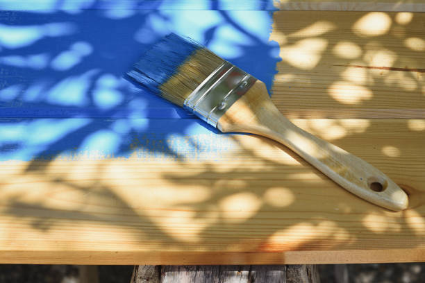 istock Pine wood board and brush with blue paint 1290317985