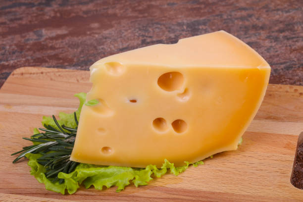 istock Maasdam cheese  in the board served salad leaves 1290318178