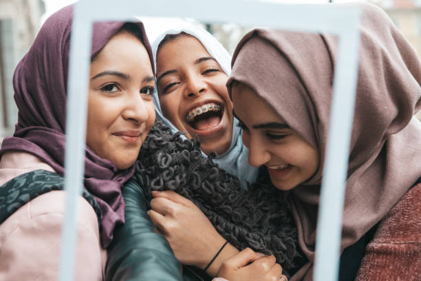 istock Three happy friends smiling to camera 1290318426