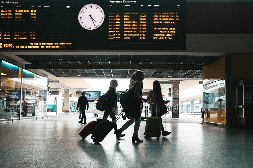 Teenage girl student friends walking at the train station