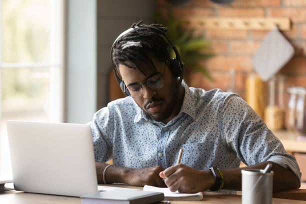 istock Concentrated 30s young mixed race guy studying at home. 1290323411