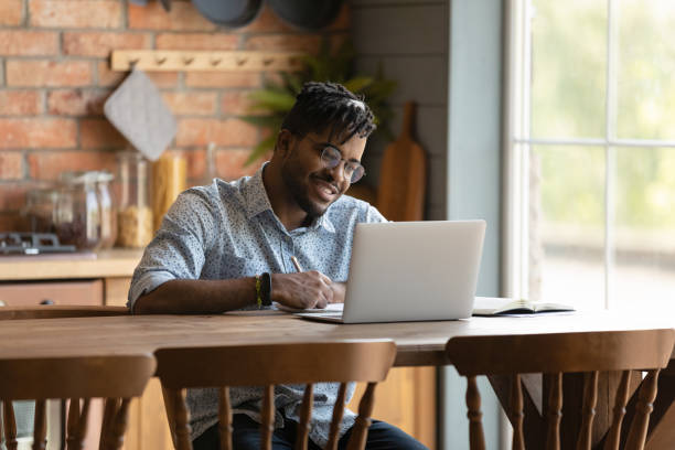 istock Happy young mixed race man enjoying learning distantly. 1290323422