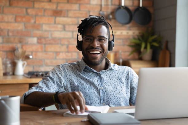 istock Happy young african american man in headset laughing. 1290323425